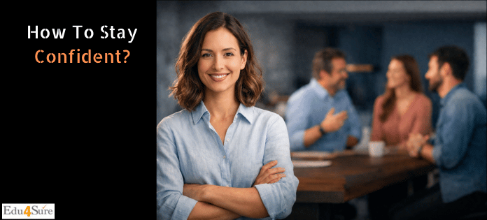 Confident professional woman smiling in an office while colleagues discuss in the background